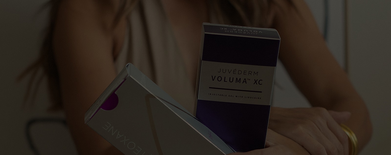 Juvederm products held by a person.